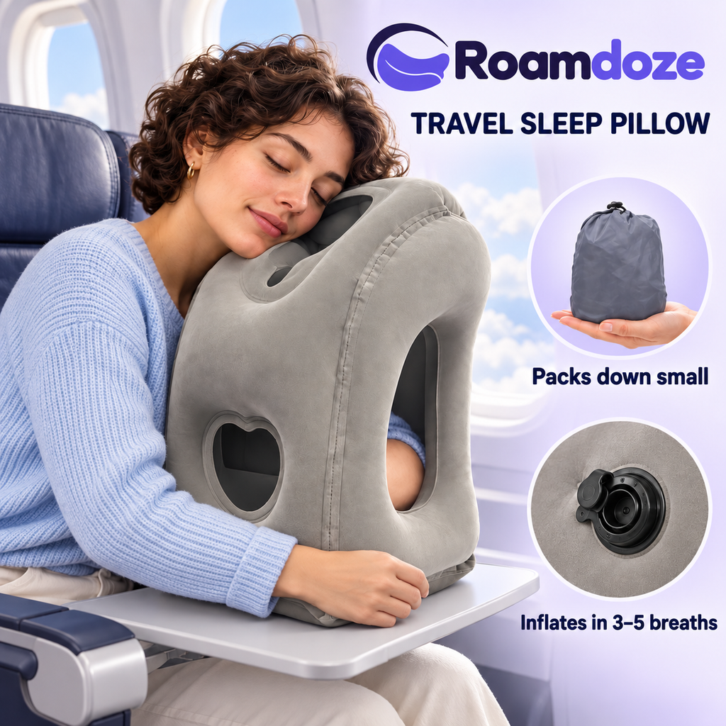 Roamdoze gray inflatable travel pillow in an airplane use scene, with the included compact drawstring pouch and mouth-inflation valve.